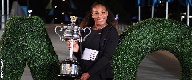 Serena Williams of the US poses with the championship trophy after her victory against Venus Williams of the US in the women's singles final on day 13 of the Australian Open tennis tournament in Melbourne