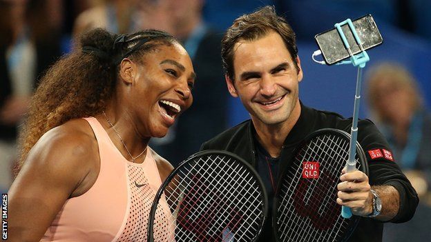 Serena Williams and Roger Federer smile as they pose together for a selfie taken by Federer