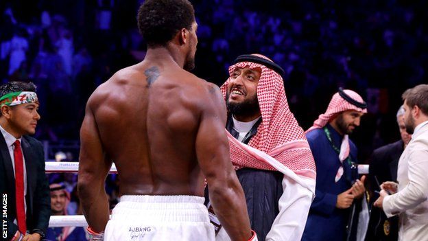 Prince Khalid Bin Abdulaziz Al Saud speaks to Anthony Joshua in the ring