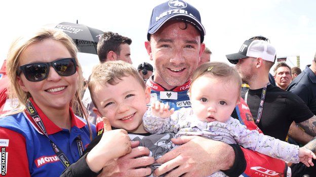 Glenn Irwin pictured with partner and children Freddy and after winning a Superbike race at the North West 200