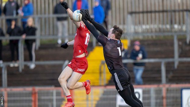 Rory Beggan fights out an aerial duel with Tyrone's Cathal McShane at Healy Park