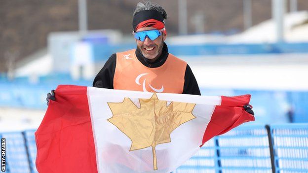 Brian McKeever with the Canadian flag