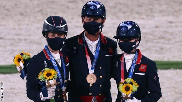 Bronze medallists Team GB's Charlotte Dujardin, Carl Hester and Charlotte Fry at the Tokyo 2020 Olympics.