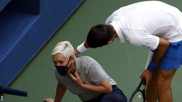 Novak Djokovic checks on the line judge after hitting her with a ball