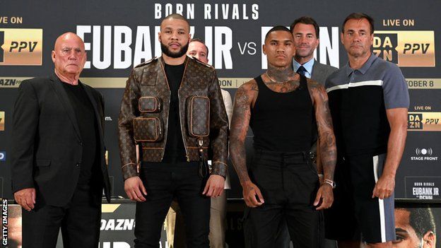 Chris Eubank Jr and Conor Benn are flanked by their trainers posing for pictures