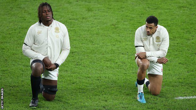 England rugby players Maro Itoje, left, and Anthony Watson take a knee before a game