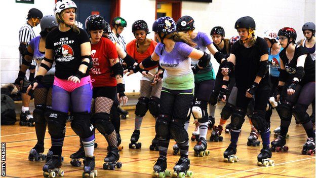 A woman leads a roller skating lesson