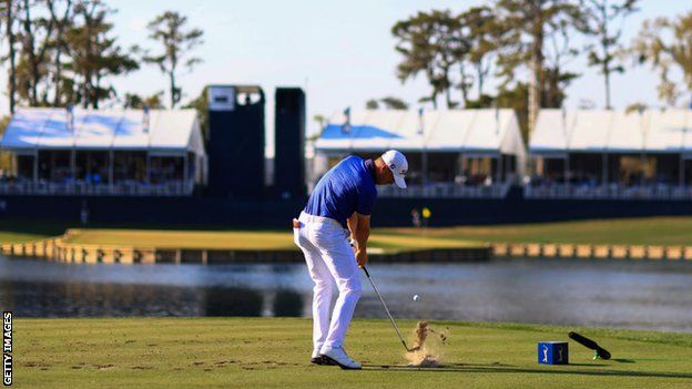 Justin Thomas hits his tee shot on the iconic par-three 17th at Sawgrass' Stadium Course