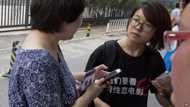 Photo taken 31 July 2014, showing activist Wei Tingting, right, outside a court