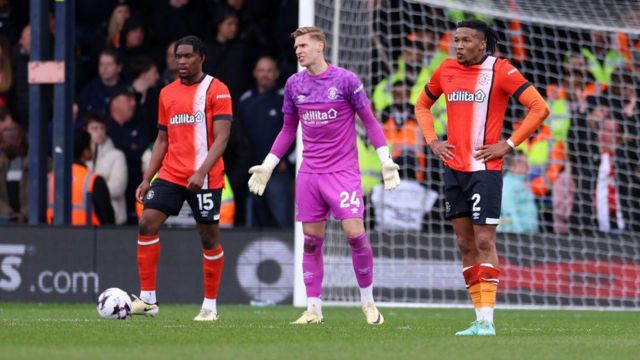 Luton players look dejected after conceding a goal