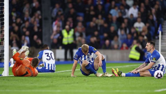 Brighton's players react after conceding against Arsenal
