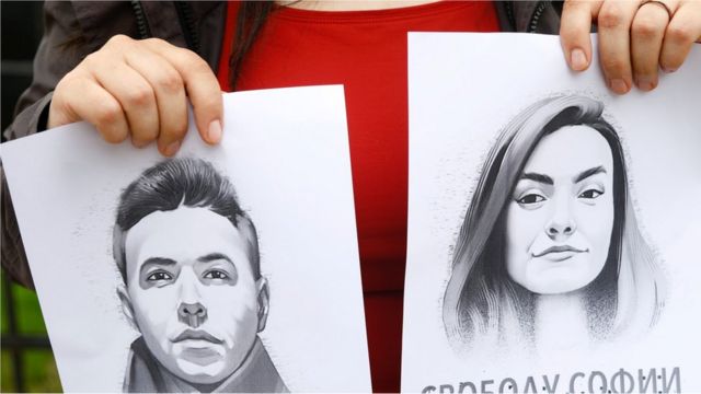 A woman holds a portrait of opposition journalist Roman Protasevich and his girlfriend Sofia Sapega during a protest of solidarity with Roman Protasevic at the Belarusian embassy in Riga, Latvia, 25 May 2021.