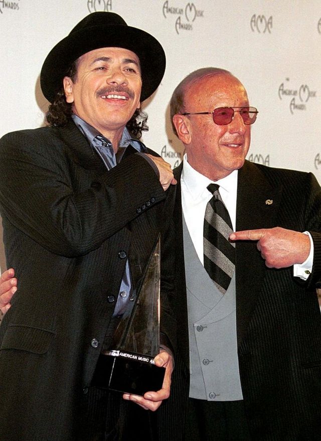 Карлос Сантана и глава фирмы Arista Records Клайв Дэвис на церемонии вручения им наград "Грэмми" за альбом Supernatural. Лос-Анджелес, 17 января 2000 г.