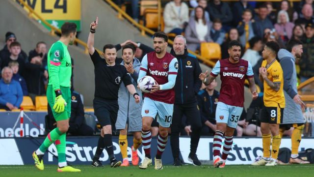 Referee Tony Harrington gestures to disallow Wolverhampton Wanderers' second goal scored by Max Kilman