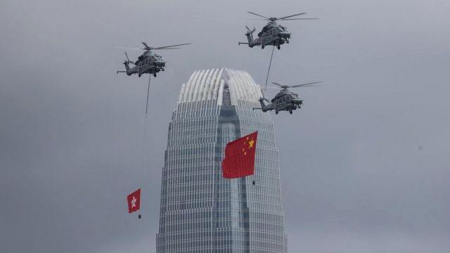 Government Flying Services aircrafts display the People's Republic of China and the Hong Kong SAR flags over the Convention Centre in Hong Kong, China, 01 July 2022