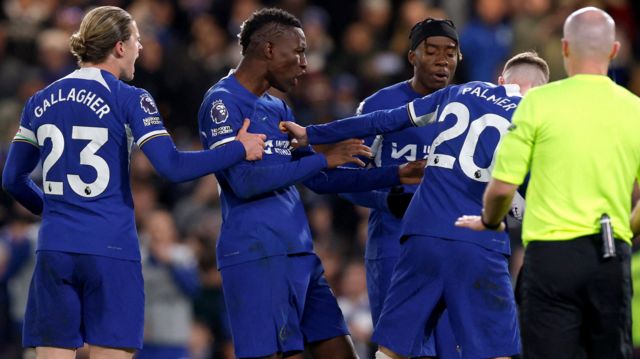 Chelsea players argue about who will take a penalty