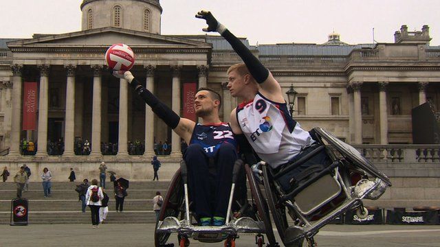 Two wheelchair rugby players posing for a photo.