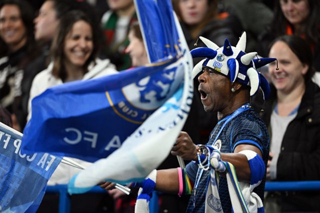 A fan of Chelsea shows their support as they wave a flag