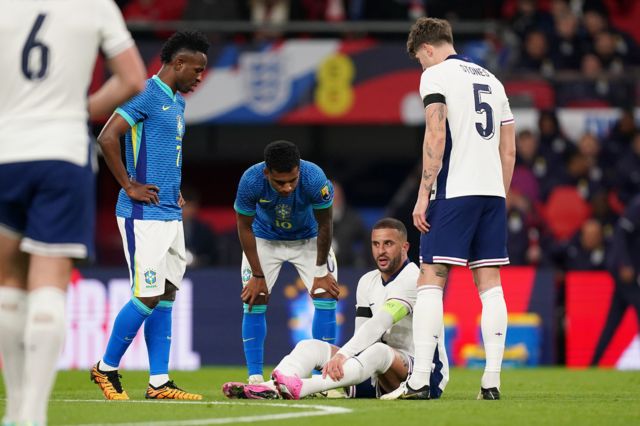 Kyle Walker waits to receive treatment after getting injured while playing for England