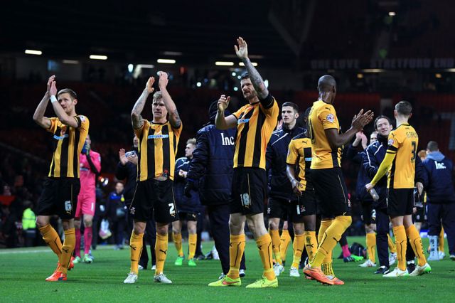 Cambridge United players applaud the team's fans after losing at Manchester United in 2015