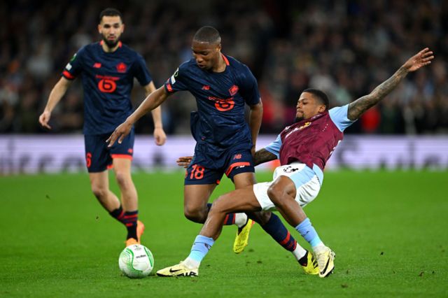 Bafode Diakite of Lille is challenged by Leon Bailey of Aston Villa