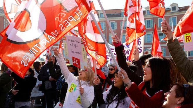 Women hold French Force Ouvriere (FO) labour union flags during a demonstration against French government's pension reform plan in Nice as part of a day of national strike and protests in France, January 31, 2023.