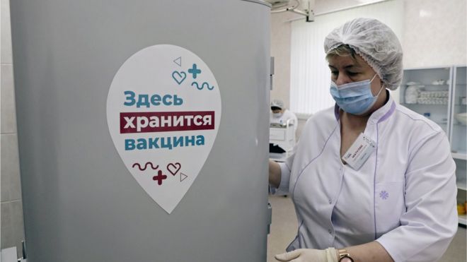 A nurse stands by a refrigerator storing the Gam-COVID-Vak (Sputnik V) vaccines at Moscow's outpatient clinic No 121