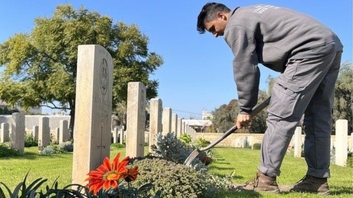 Mohammed Atalah tending a grave