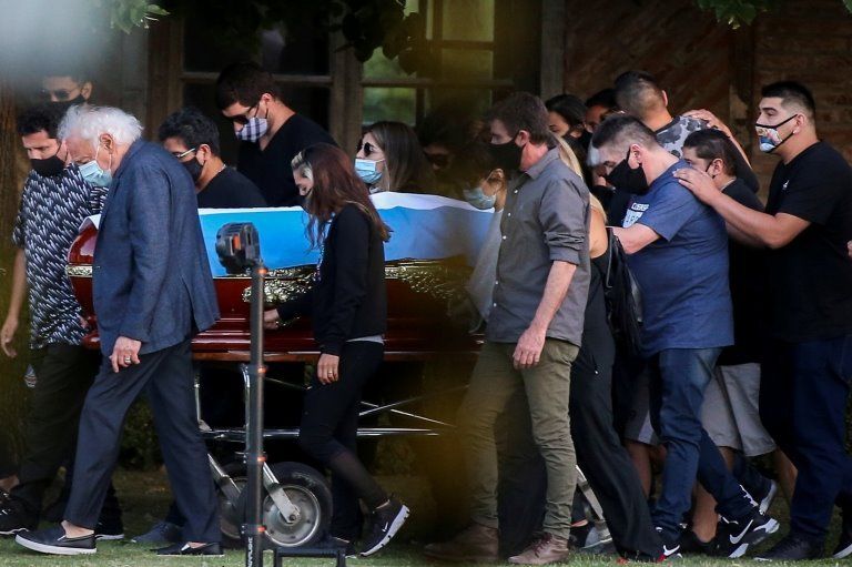 Friends and family carry the casket of soccer legend Diego Armando Maradona, at the cemetery in Buenos Aires, Argentina, November 26, 2020.