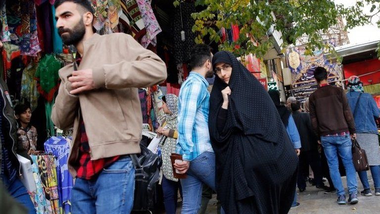 Iranians shop in a bazaar in Tehran