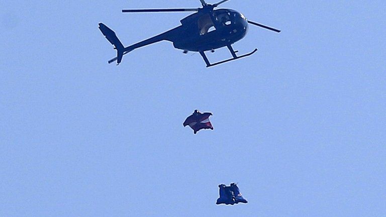 Stuntman Gary Connery (bottom) and cameraman Mark Sutton (top) are seen in the sky wearing specially developed wingsuits