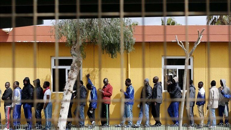 African migrants queue for lunch inside a refugee centre in the Spanish enclave of Melilla