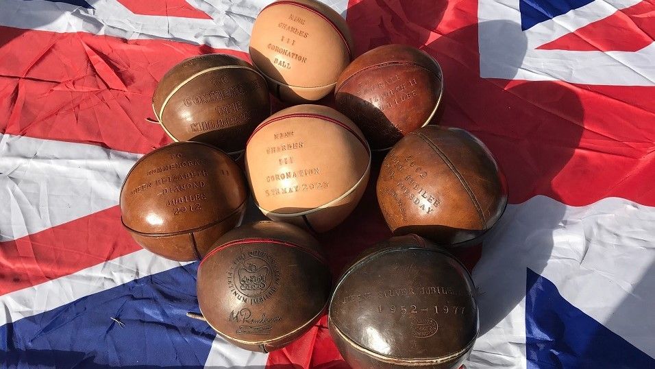 Old match balls on a Union Jack flag