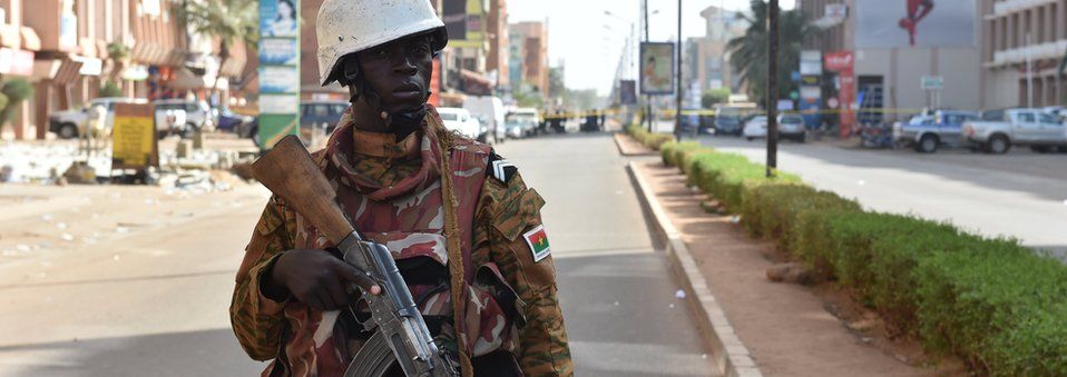 A soldier of Burkina Faso"s army stands guard outside the Splendid Hotel and nearby Cappuccino restaurant following a jihadist attack in Ouagadougou