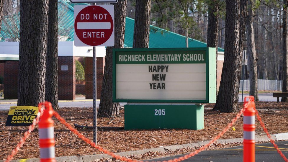 A school sign wishing students a "Happy New Year" is seen outside Richneck Elementary School in Virginia, where authorities say a six-year-old shot their teacher.