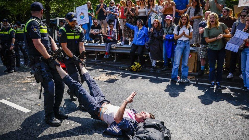 Police officers remove an activist from the Extinction Rebellion protest group on the A12, during the 'XR opposes fossil subsidies' demonstration in The Hague, The Netherlands, 27 May 2023.