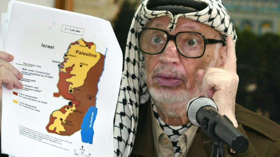 Yasser Arafat with a map of the West Bank (file photo)