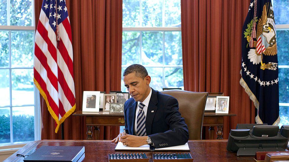 President Barack Obama signs the Budget Control Act of 2011 in the Oval Office August 2, 2011