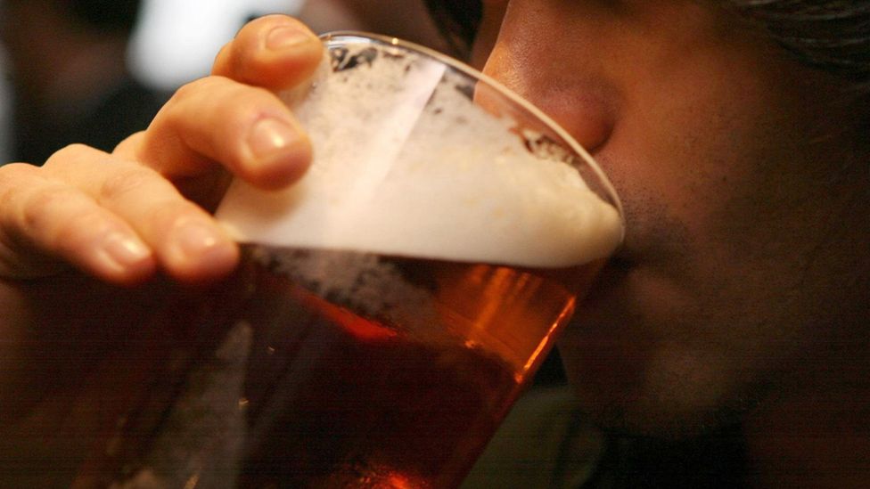 Man drinking pint of beer