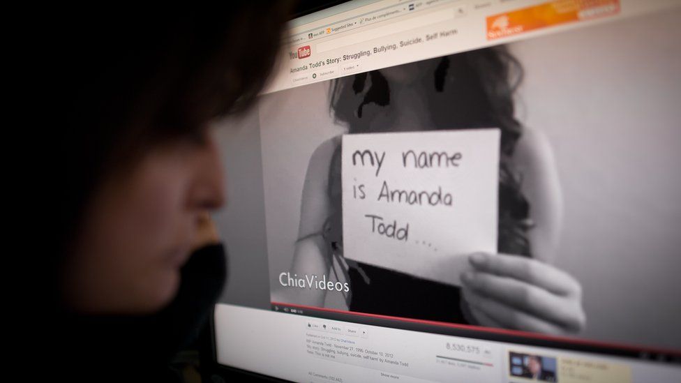 A girl watches the Amanda Todd YouTube clip