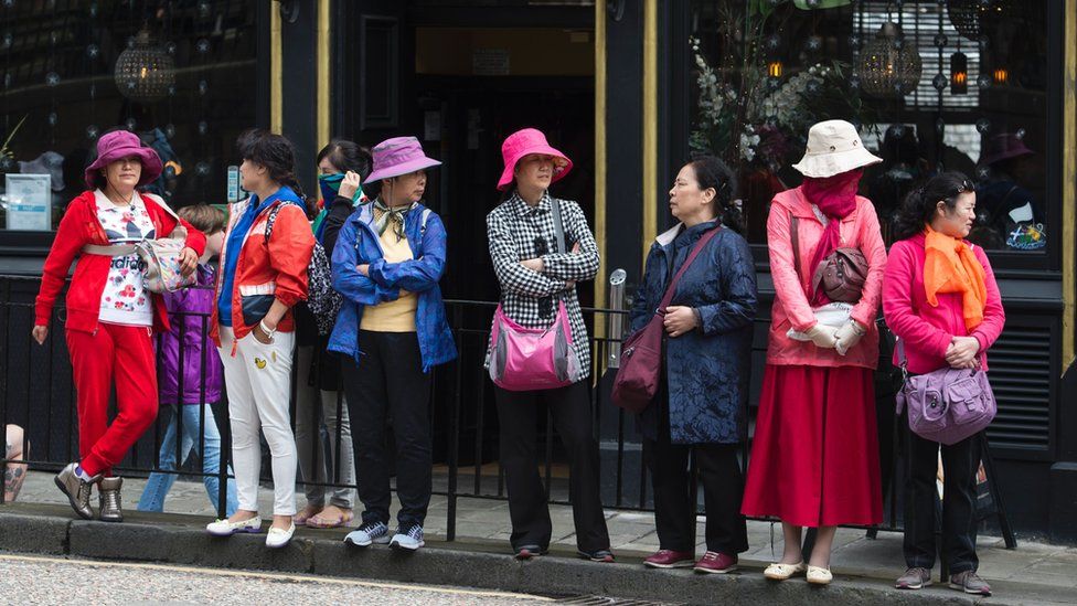 Tourists stand outside a pub in Edinburgh, Scotland on June 25, 2016, following the pro-Brexit result of the UK's EU referendum vote