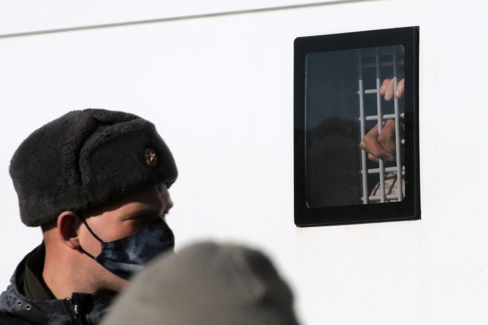 A man detained during a unsanctioned protest rally at Manezhnaya Square in front of the Kremlin,