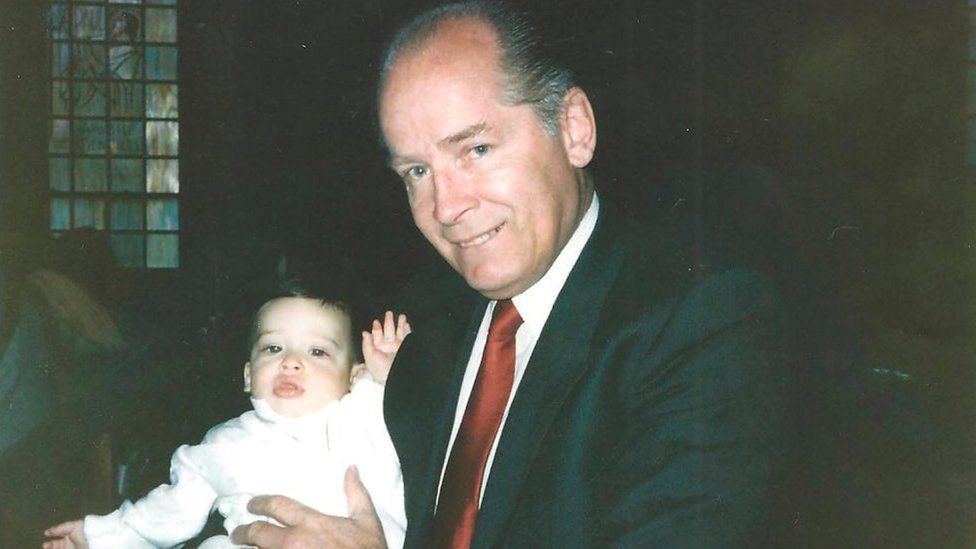 Bulger holds a lieutenant's son during his christening ceremony in this undated handout photo