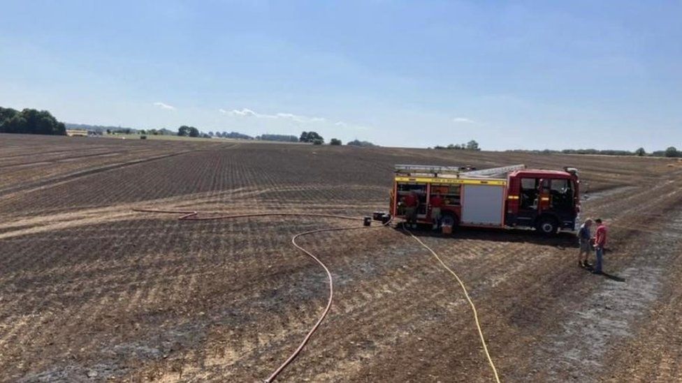 A fire engine on scorched fields