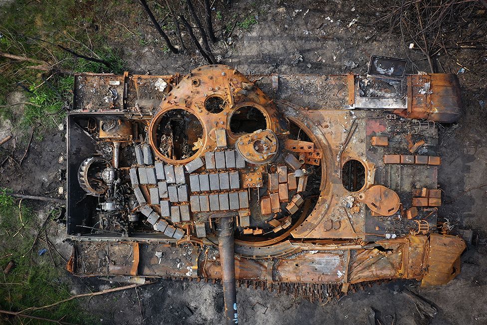 A destroyed Russian tank begins to rust in woodland near Kyiv, Ukraine, on 7 June 2022