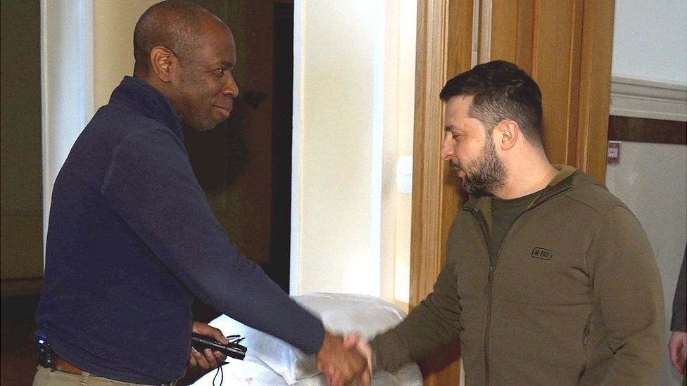 Volodymyr Zelensky shaking hands with Clive Myrie