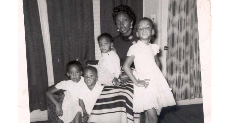 Mother and children posing for a photo at home