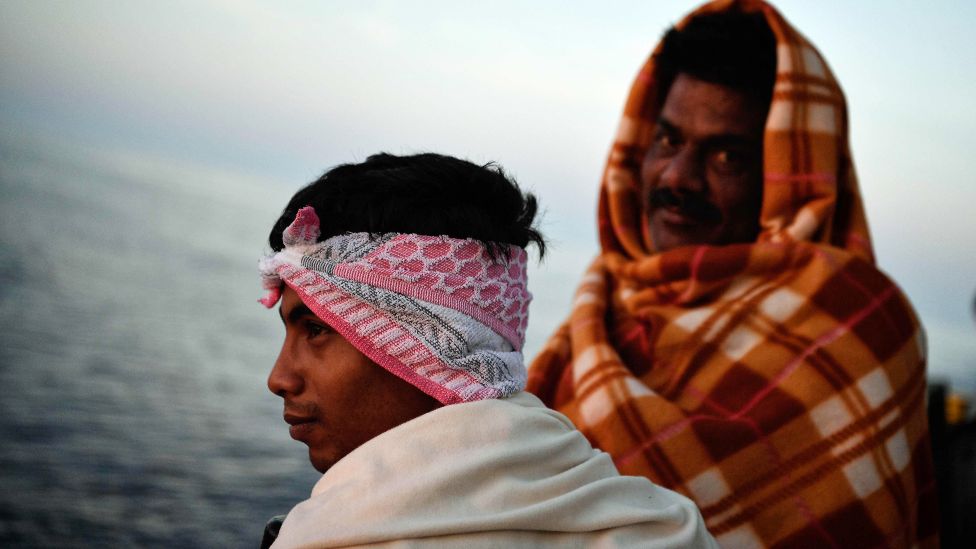 Bangladeshi migrants look at the sunrise onboard a Mediterranean rescue ship - May 2018