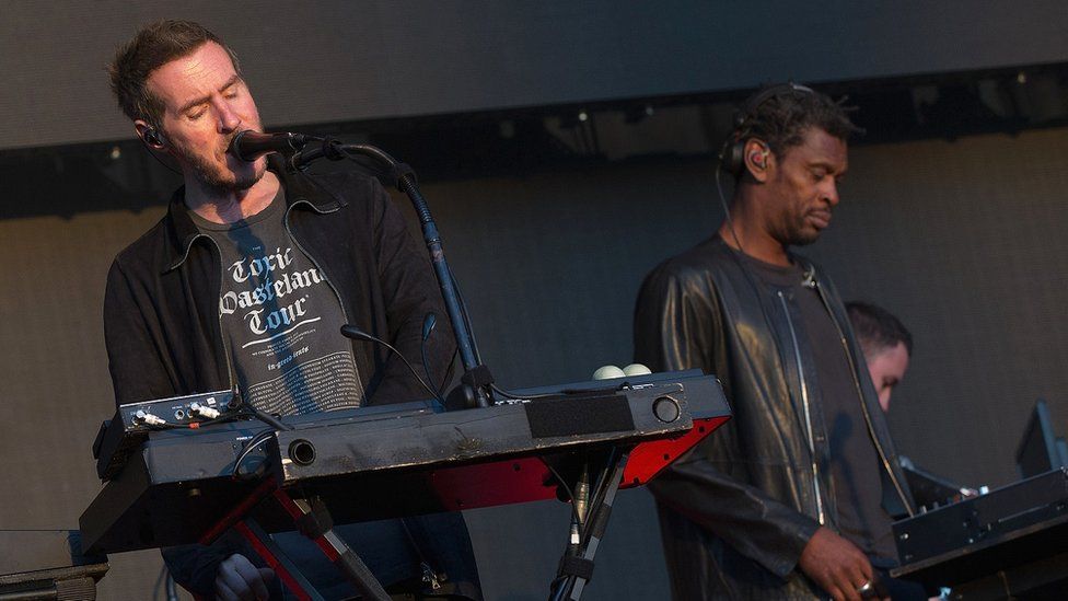Members of Massive Attack performing on stage