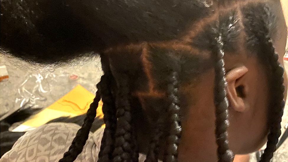 Keziah getting braids put in.